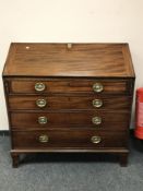 An early 19th century mahogany bureau,