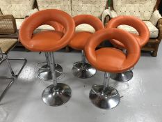 Five orange leather gas lift bar stools