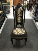 A 19th century floral tapestry side chair on cabriole legs with brass castors,