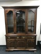 A colonial style triple door display cabinet