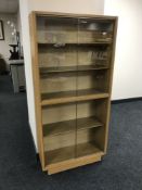 A teak sliding door bookcase