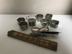 A box of six pewter napkin rings, plated salt with spoon and blue glass liner,