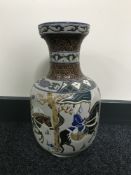 A 20th century Oriental pottery vase depicting warriors on horseback