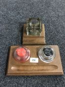 Two wooden desk stands with glass inkwells