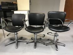 A set of three chrome framed hydraulic beauticians chairs