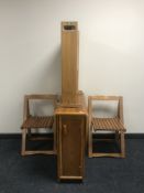 A drop leaf storage table and four chairs plus a pine drop leaf table