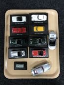 Nine die cast vehicles mounted on plastic stands and two James Bond die cast vehicles