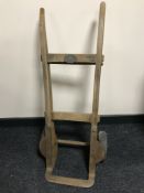 A vintage wooden hand truck bearing a Great Western Railway plaque