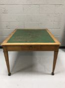 A late Victorian inlaid ash leather topped library table fitted with drawers