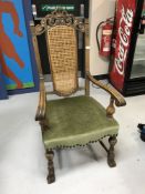 An 18th century style oak gentlemen's armchair with bergere back