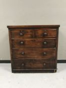 A Victorian stained pine five drawer chest