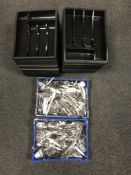 Two plastic crates of assorted stainless steel cutlery and cutlery trays