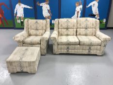 A three piece lounge suite in floral fabric