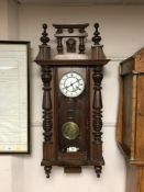 A continental mahogany eight day wall clock with enamel dial