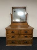A satin walnut four drawer dressing chest