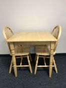 A kitchen table and two chairs