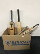 A box of cricket bats and stumps