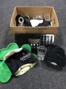 A box of Guinness pub merchandise - hat, glasses,
