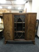 A mid 20th century walnut glazed door display cabinet