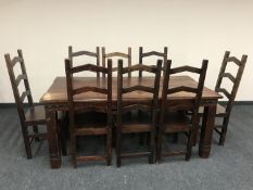 An Indonesian hardwood dining table and eight ladder backed chairs