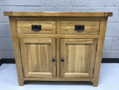 A contemporary oak two drawer two door sideboard
