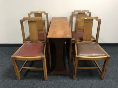 A teak G plan drop leaf table and four oak chairs