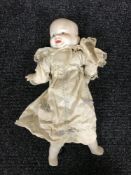 An early 20th century bisque headed three faced doll
