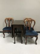 A drop leaf table and three Victorian dining chairs