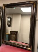 A contemporary overmantel mirror in bronzed frame,