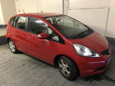 A Honda Jazz hatchback motor car, red, 1.