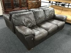 A pair of brown leather three seater settees