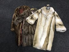 Two lady's fur coats and a simulated fur coats