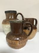 Three Royal Doulton stone ware jugs one with a silver rim