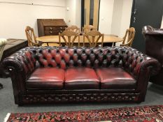 An oxblood leather three seater Chesterfield settee,