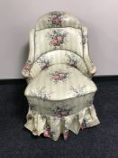 A 19th century bedroom chair, with shaped back, upholstered in floral fabric,