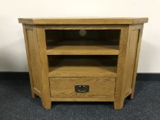 An oak corner TV stand fitted a drawer