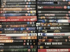 Four boxes of assorted DVDs