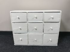 A painted pine nine drawer chest