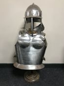 A military style helmet and breast plate on stand