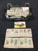 A box of cigarette and tea cards in albums.