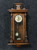 A walnut Vienna wall clock with pendulum and key