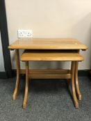 A contemporary elm nest of two tables,