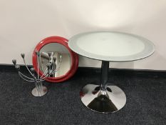 A circular mirrored top occasional table on chrome,