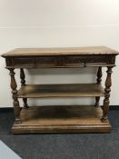 An early 20th century carved oak dumb waiter