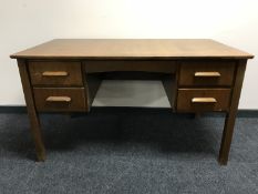 A mid 20th century oak twin pedestal desk