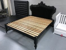 A pine 6' bed frame and a black Rococo style headboard in black button fabric
