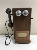 A vintage oak cased telephone box with bakelite hand set