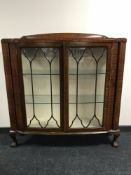 A mahogany display cabinet on claw and ball feet