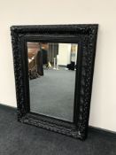 A Victorian style black framed mirror