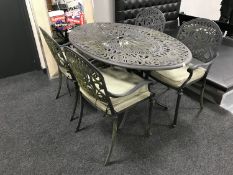 A cast metal oval patio table,